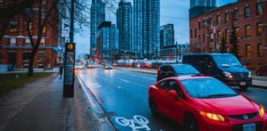 wet city street with cars and tall buildings for Pennsylvania commercial auto insurance