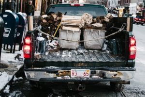 Black truck transporting goods on a snowy day for Pennsylvania Commercial and Surety Bonds