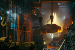 Factory with cranes lifting machinery for Pennsylvania manufacturers insurance