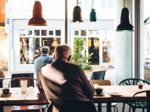 image of an older man sitting and reading at a table for — Pennsylvania Life Insurance