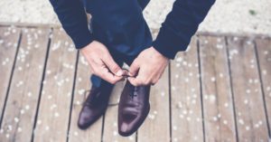 person in business clothes tying their shoes for Pennsylvania Management Liability Insurance