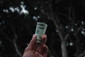 person holding rolled up money for Pennsylvania non profit insurance