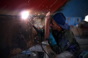 image of a man using welding equipment for Pennsylvania Workers Compensation Insurance